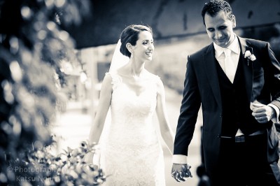 b&w wedding photo of bride and groom holding hands